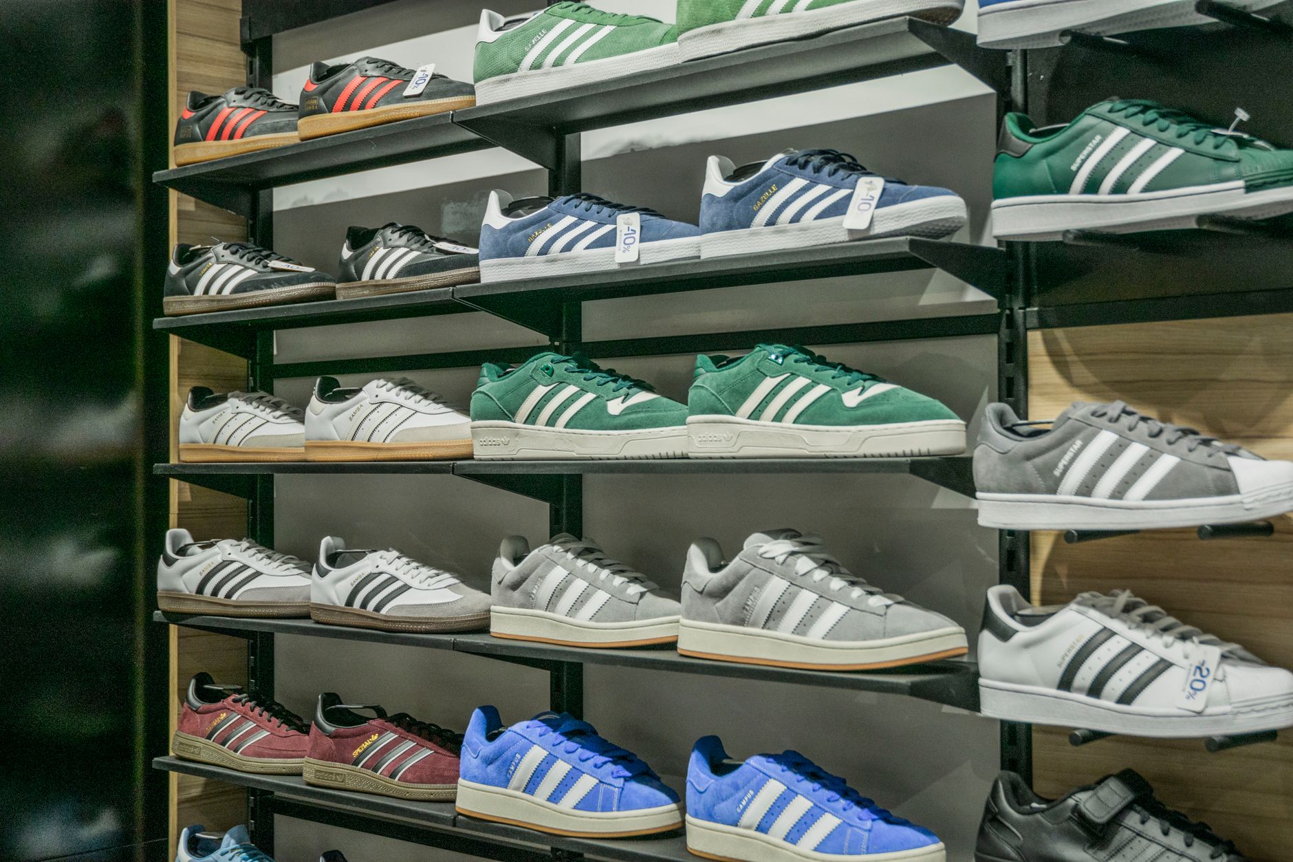 Colorful sneakers arranged on store shelves showcasing trendy footwear options.