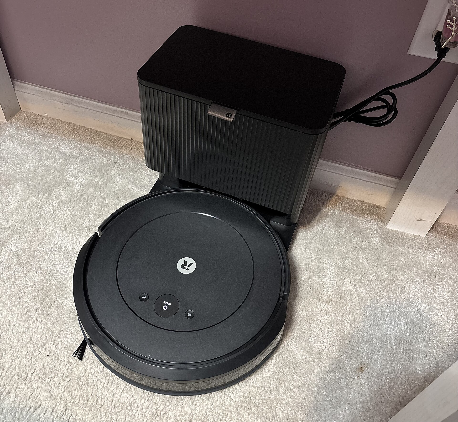 A Roomba Combo 2 Essential robot vacuum and mop, parked on its charging dock.