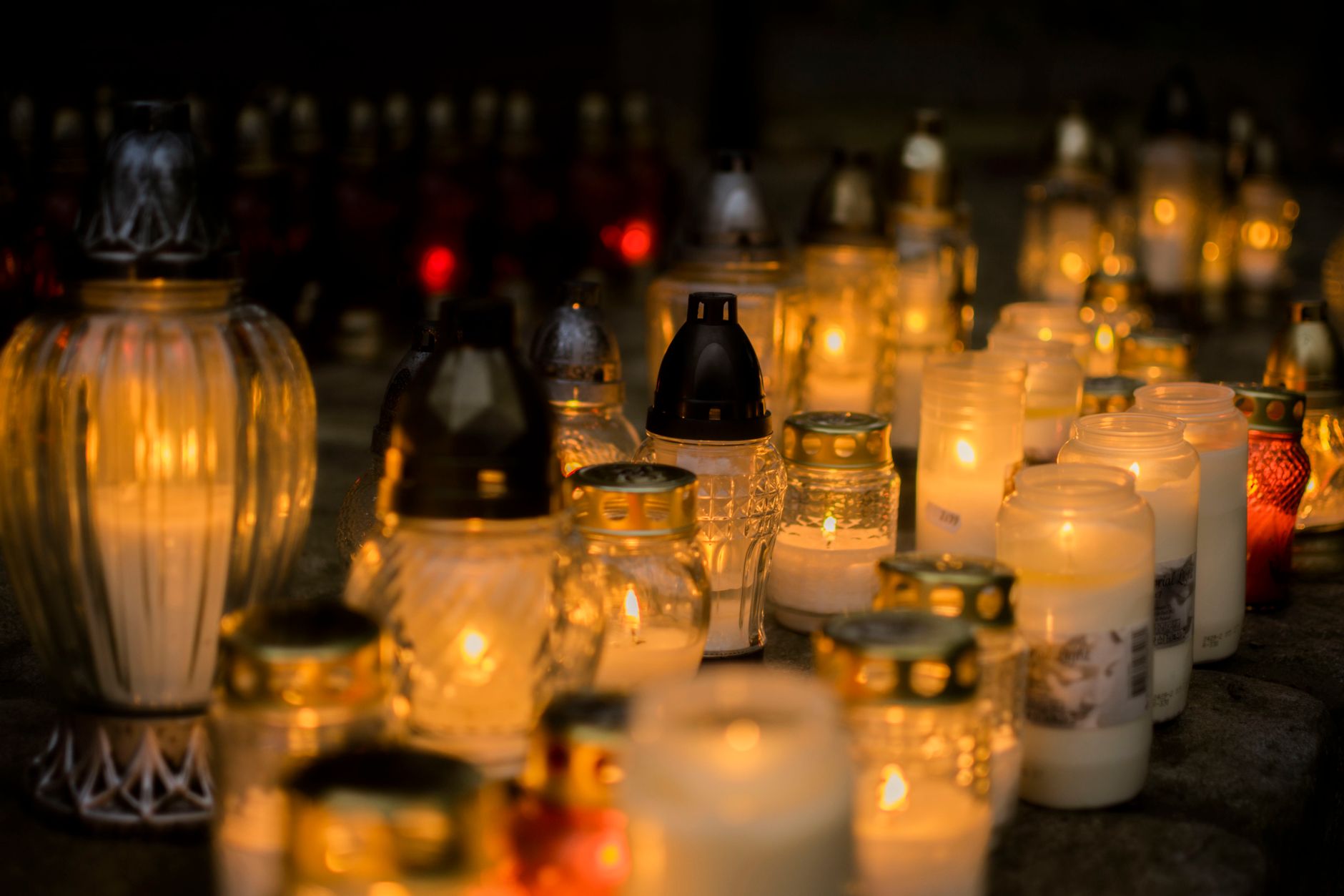 Lit candles on a grave, a serene tribute for All Saints' Day, Poland.